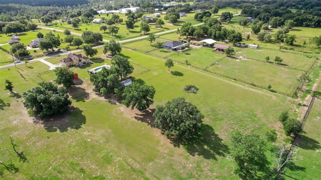 An aerial view shows a rural property with multiple houses, fenced pastures, and large trees — 35405 STAGECOACH TRAIL, EUSTIS, FL