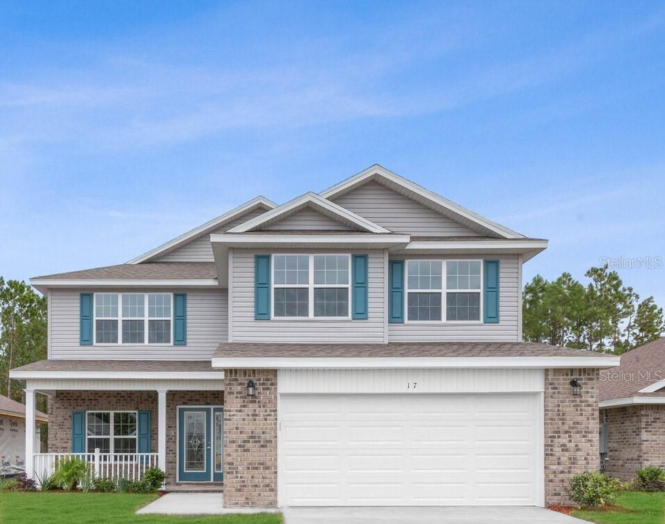 A two-story house features light gray siding, a brick facade, and a two-car garage — 18 RENMONT PLACE, PALM COAST, FL