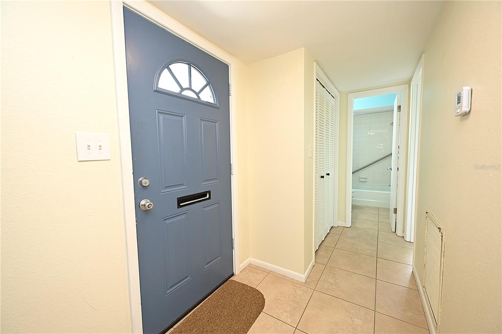 A kitchen features white cabinets, butcher block countertops, a black refrigerator, and tile flooring — 3535 AMITY AVENUE UNIT 3535, LAKELAND, FL