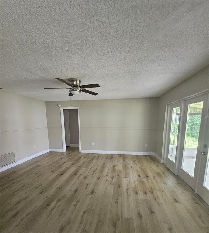 A single-story beige concrete block house with a dark shingled roof and attached garage — 4518 GASPARILLA AVENUE, ORLANDO, FL