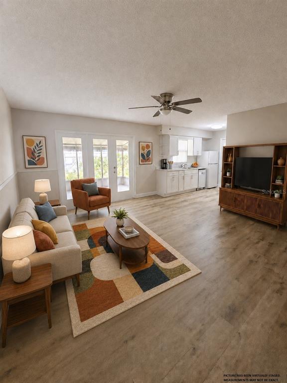 An empty room with wood-look flooring, beige walls with wainscoting, and a ceiling fan — 4518 GASPARILLA AVENUE, ORLANDO, FL