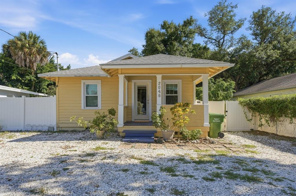 A kitchen with white cabinets, granite countertops, a mosaic tile backsplash, and two windows — 2048 5TH STREET, SARASOTA, FL