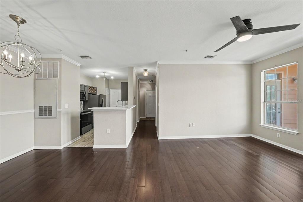 A living room features a sofa, two armchairs, a coffee table, and a wall-mounted television — 5000 CULBREATH KEY WAY UNIT 4203, TAMPA, FL