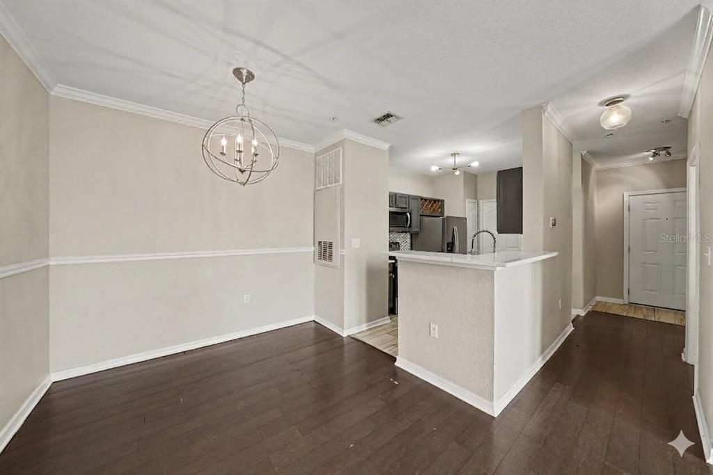 An empty room with dark wood flooring, a ceiling fan, and a wall-mounted television bracket — 5000 CULBREATH KEY WAY UNIT 4203, TAMPA, FL