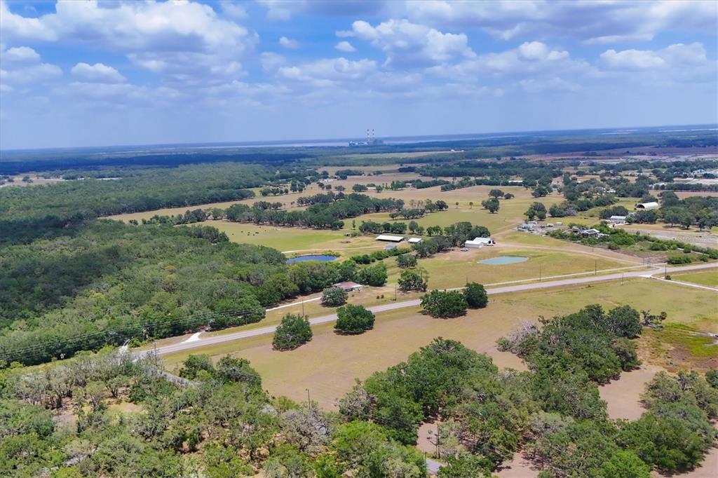 An aerial view shows a rural landscape with pastures, scattered trees, ponds, and a road — 6720 JIM DAVIS ROAD, PARRISH, FL