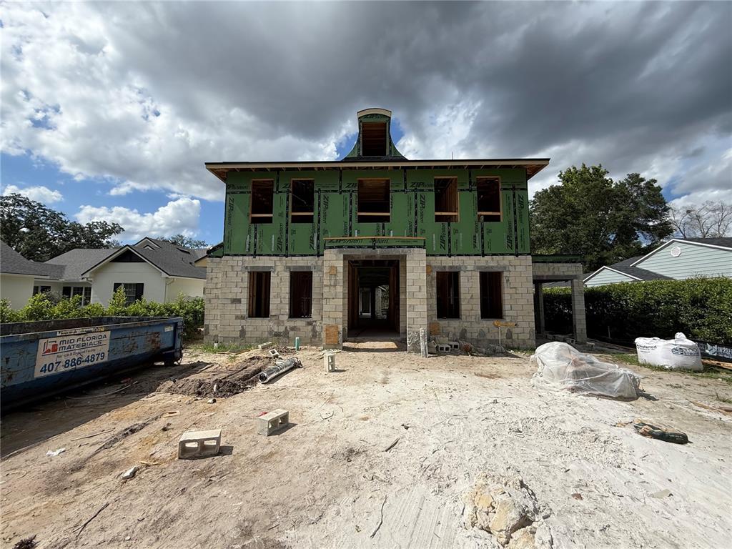 A two-story house under construction with green sheathing and a concrete block exterior — 207 E KINGS WAY, WINTER PARK, FL