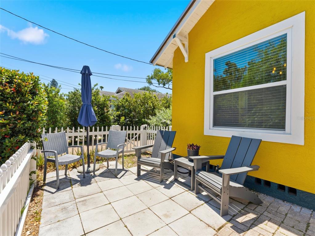 A bright entryway features a wooden bench, a glass-paned door, and wood-look tile flooring — 2005 3RD STREET S, ST PETERSBURG, FL