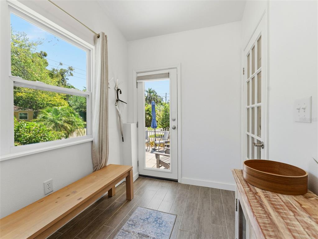 A dining room features a white oval table, modern chairs, a chandelier, and wood flooring — 2005 3RD STREET S, ST PETERSBURG, FL