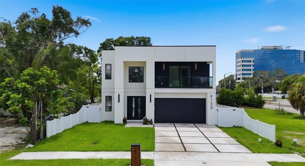 A modern two-story house with a white exterior, black accents, and a concrete driveway — 4122 W NASSAU STREET, TAMPA, FL