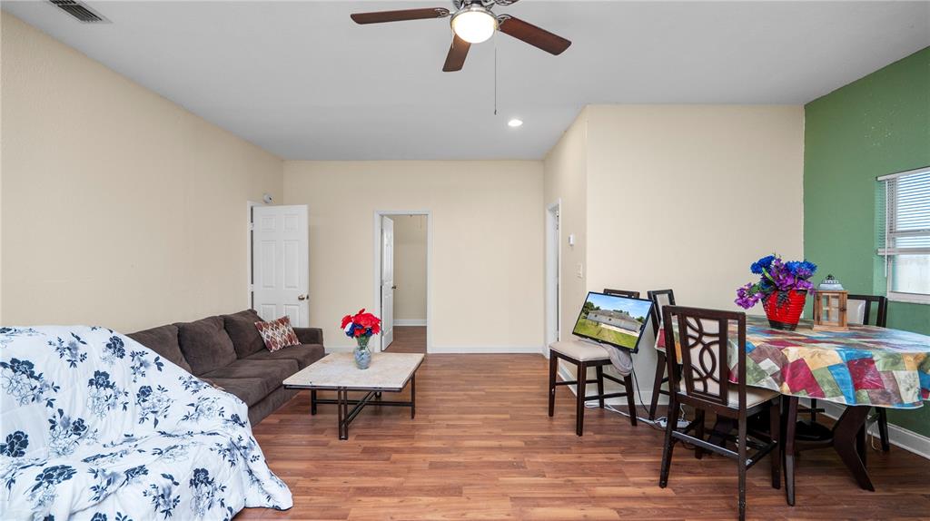 An aerial view shows a house and a detached garage on a grassy lot — 611 MORGAN ROAD, WINTER HAVEN, FL