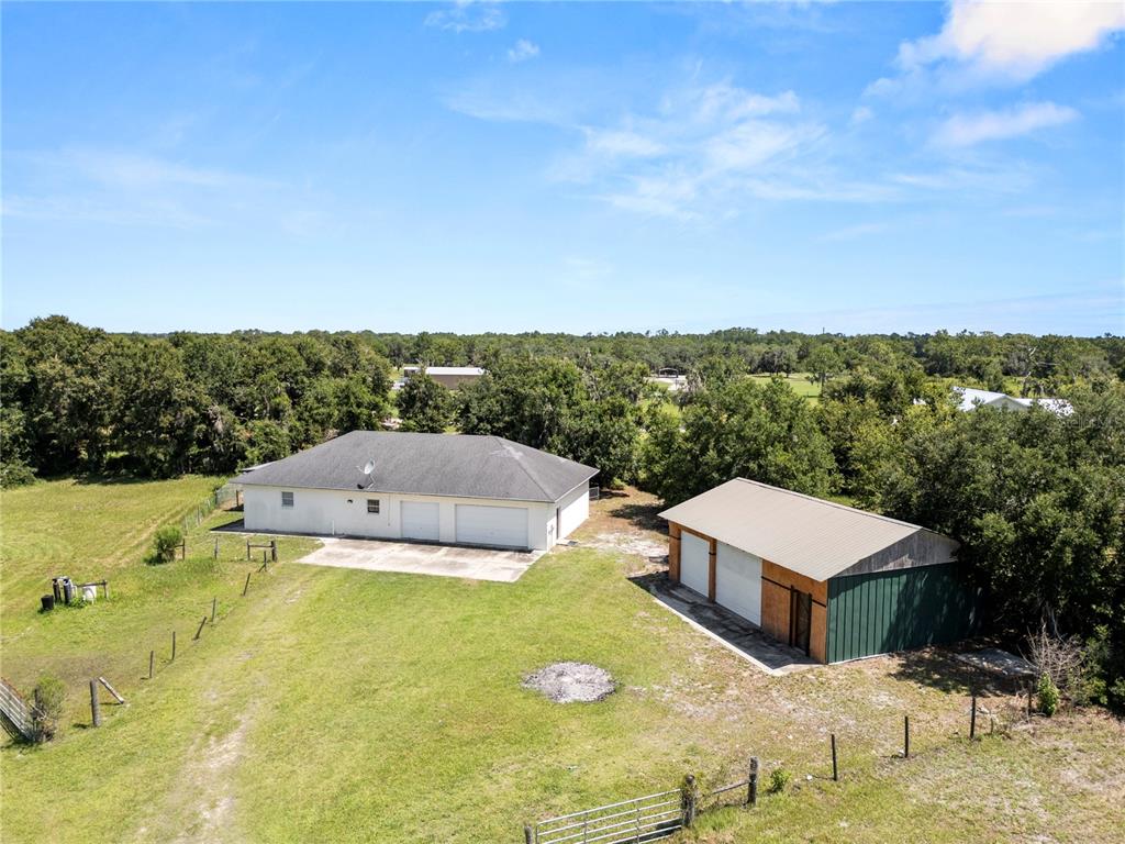 An aerial view shows a rural property with two houses and outbuildings enclosed by red lines — 611 MORGAN ROAD, WINTER HAVEN, FL