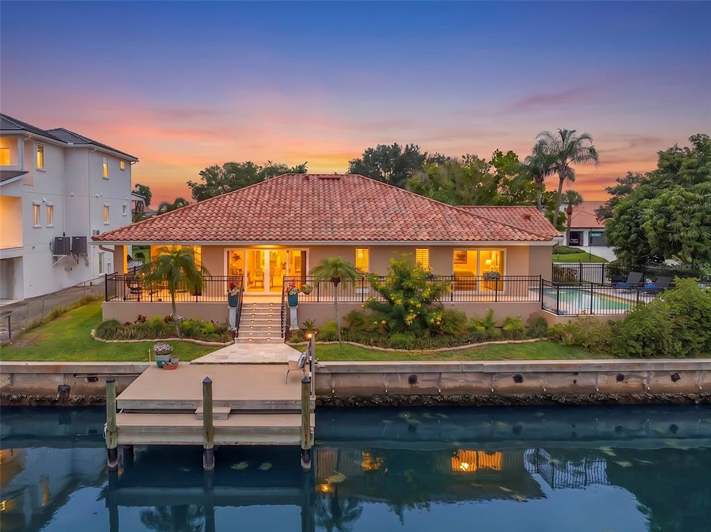 A single-story house with a tiled roof, a two-car garage, and a paved driveway — 2001 ILLINOIS AVE NE, ST PETERSBURG, FL
