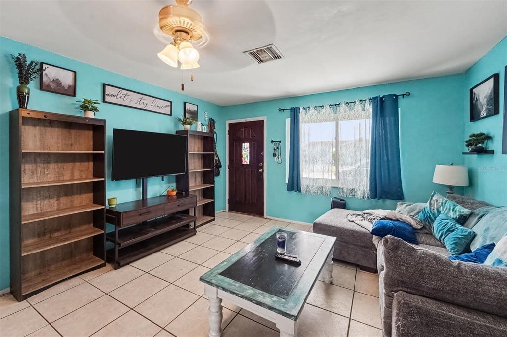 A single-story house with a blue exterior, a front-facing garage, and a concrete driveway — 8143 HIXTON DRIVE, PORT RICHEY, FL