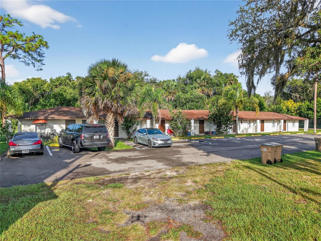 A single-story apartment building with a parking lot in front and surrounding trees — 37415 STATE ROAD 19, UMATILLA, FL