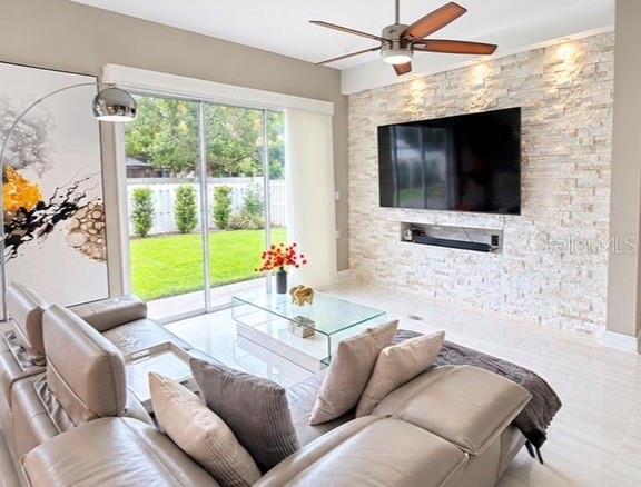 A dining area features a glass table, modern chandelier, and floor-to-ceiling windows overlooking a patio — 10133 FACET COURT, ORLANDO, FL