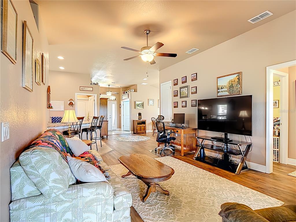 A wooden hutch and console table sit against a wall decorated with framed art — 1170 LEGATTO LOOP, DUNDEE, FL