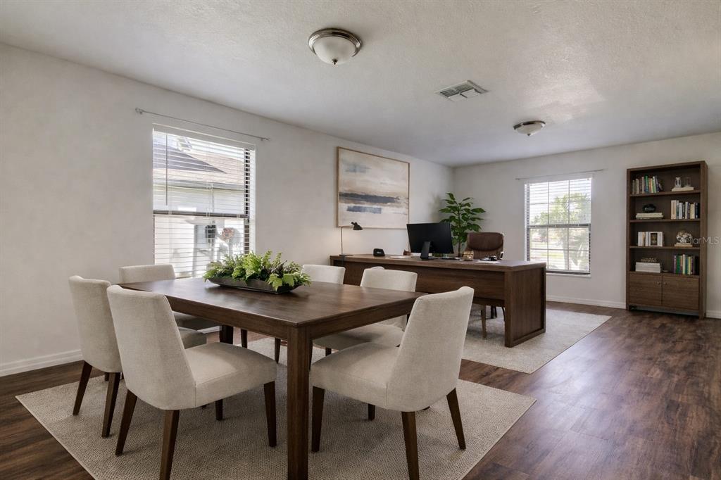 A room featuring a dining table with chairs and a desk area with a bookshelf — 1739 CHATHAM GREEN CIRCLE, RUSKIN, FL