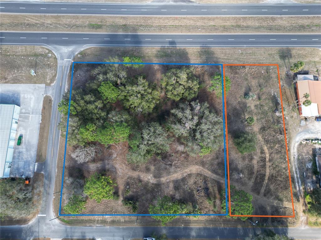 An aerial view shows two adjacent vacant lots outlined in blue and orange — 7280 SE 123RD LANE, BELLEVIEW, FL
