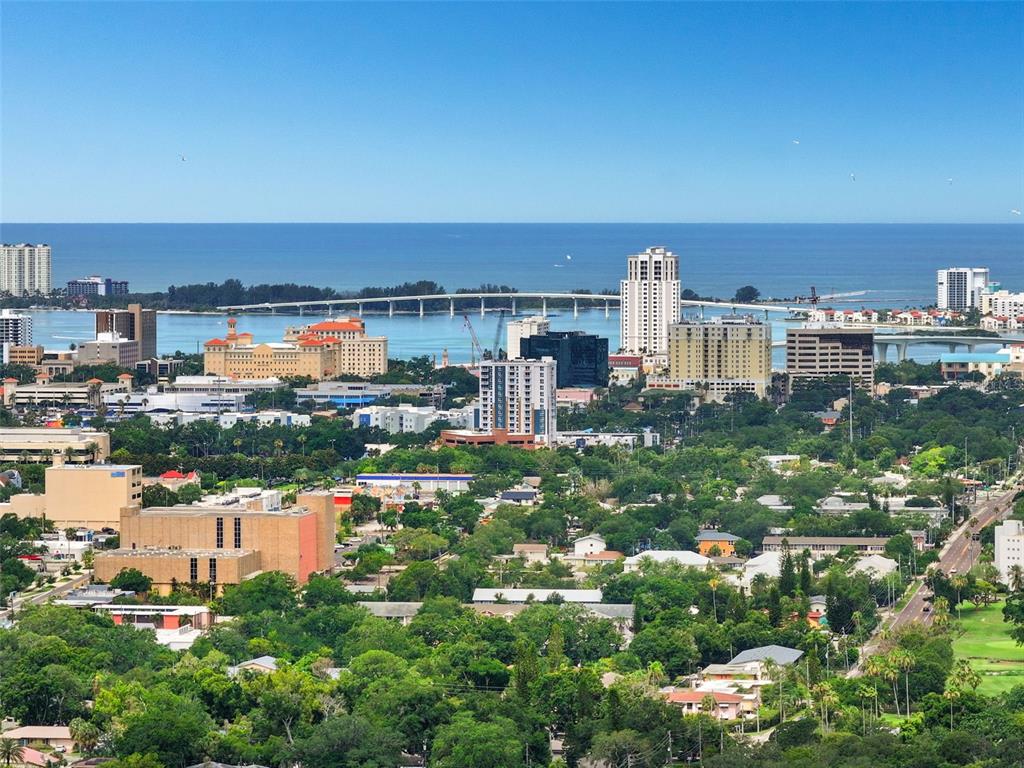An elevated view of a coastal city skyline featuring high-rise buildings, a bridge, and ocean — 210 EDGEWOOD AVENUE, CLEARWATER, FL