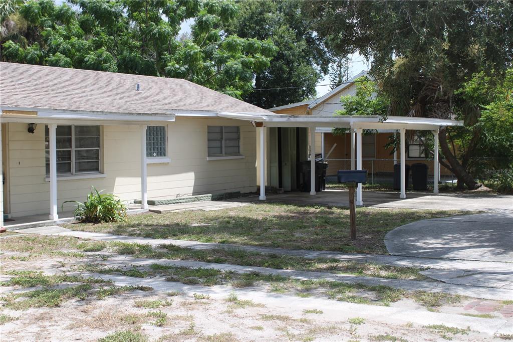 A single-story house with a beige exterior, a covered porch, and an attached carport — 2337 N CRYSTAL LAKE DRIVE, LAKELAND, FL