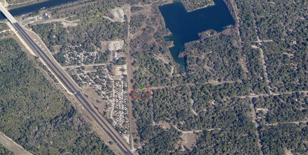 An aerial view shows a rectangular plot of land outlined in red near a highway — 9999 N SNOWBALL POINT, CRYSTAL RIVER, FL