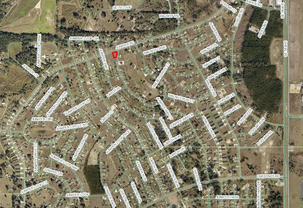 This is an aerial map showing a residential neighborhood with a highlighted property lot — JUNIPER LOOP CIR, OCALA, FL