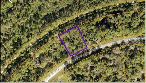 This is an aerial map view showing a highlighted vacant residential lot along a road — SILVERLEAF ROAD, NORTH PORT, FL