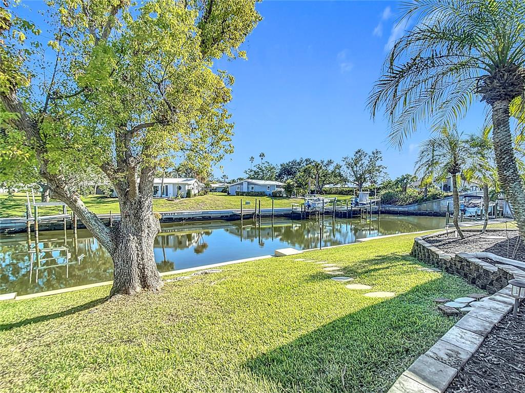 An aerial view shows a coastal waterway with mangrove islands, shallow turquoise water, and sandbars — 4 WINDSOR DRIVE, ENGLEWOOD, FL