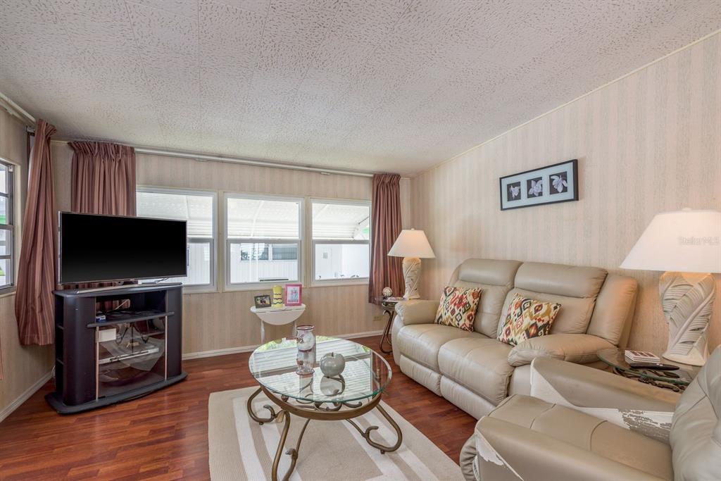 A white mobile home with a screened-in front porch and an attached carport — 2331 BELLEAIR ROAD UNIT 514, CLEARWATER, FL
