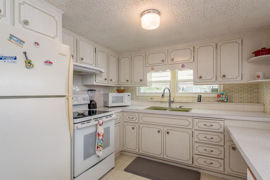 A white single-wide mobile home with a carport and a small front yard — 2331 BELLEAIR ROAD UNIT 514, CLEARWATER, FL