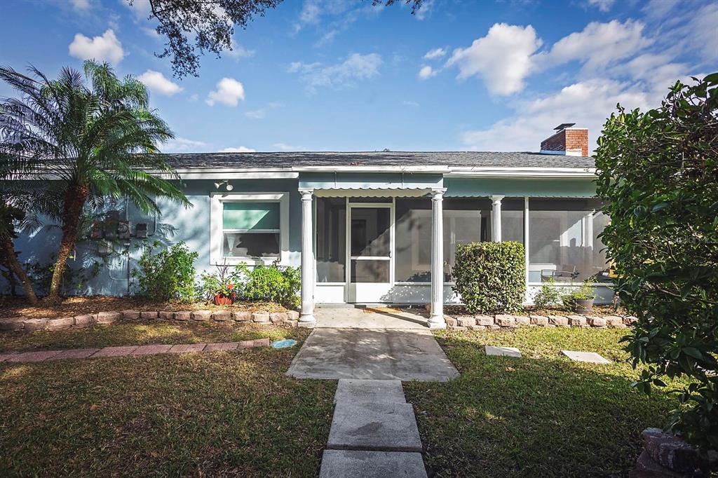 A light blue house features a screened-in front porch with white columns and a walkway — 2614 FAIRVIEW AVENUE, SEFFNER, FL