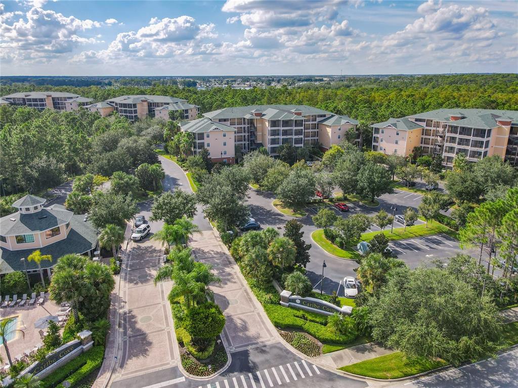 An aerial view of the Caribe Cove resort complex featuring multi-story buildings and parking lots — 3050 PIRATES RETREAT COURT UNIT 207, KISSIMMEE, FL