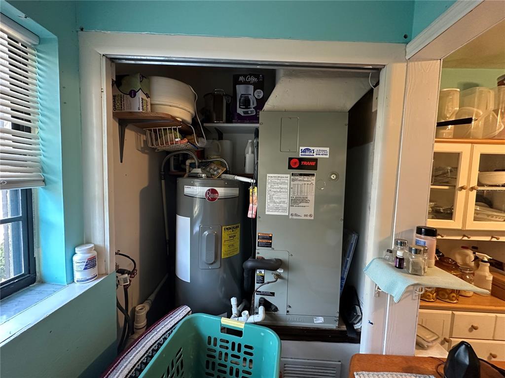 A utility closet contains a water heater and a Trane HVAC unit — 913 MICHIGAN AVENUE, ST CLOUD, FL
