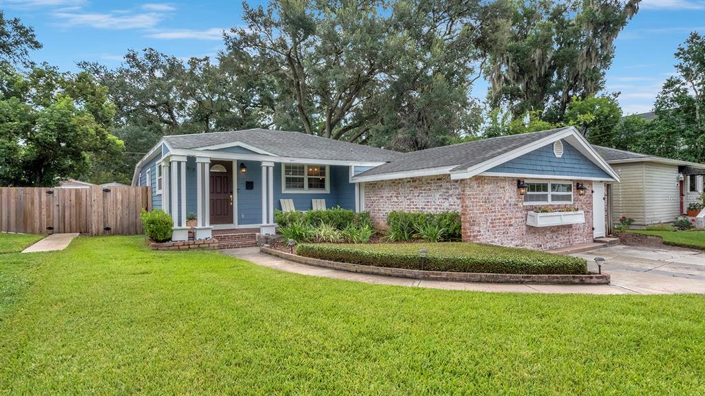 A single-story house with blue siding, a brick facade, and a large front lawn — 1819 LAKE SUE DRIVE, ORLANDO, FL
