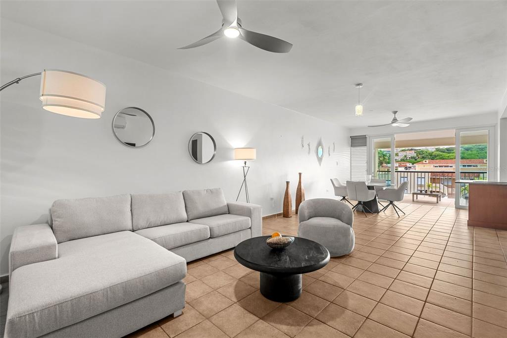 A two-story yellow apartment building with an exterior staircase and a parked golf cart — Harbour Lakes PALMAS DRIVE UNIT 60 D, HUMACAO, PR