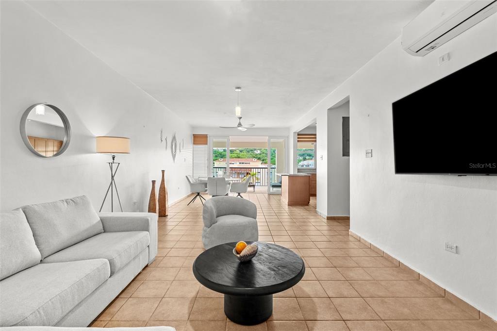 A two-story yellow stucco building with a central staircase and a golf cart parked outside — Harbour Lakes PALMAS DRIVE UNIT 60 D, HUMACAO, PR