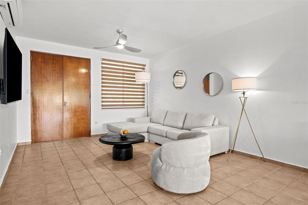 A two-story stucco apartment building with exterior stairs and palm trees at dusk — Harbour Lakes PALMAS DRIVE UNIT 60 D, HUMACAO, PR