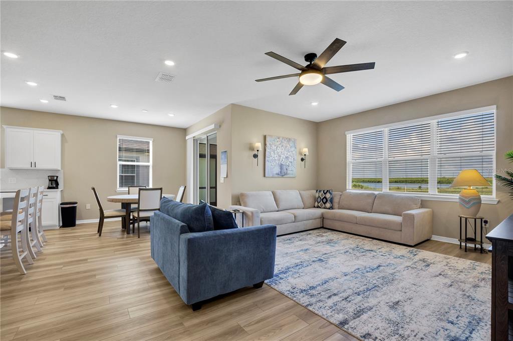 A single-story suburban house with a gray exterior, a two-car garage, and a concrete driveway — 1046 SILVERLAKE BOULEVARD, LAKE ALFRED, FL