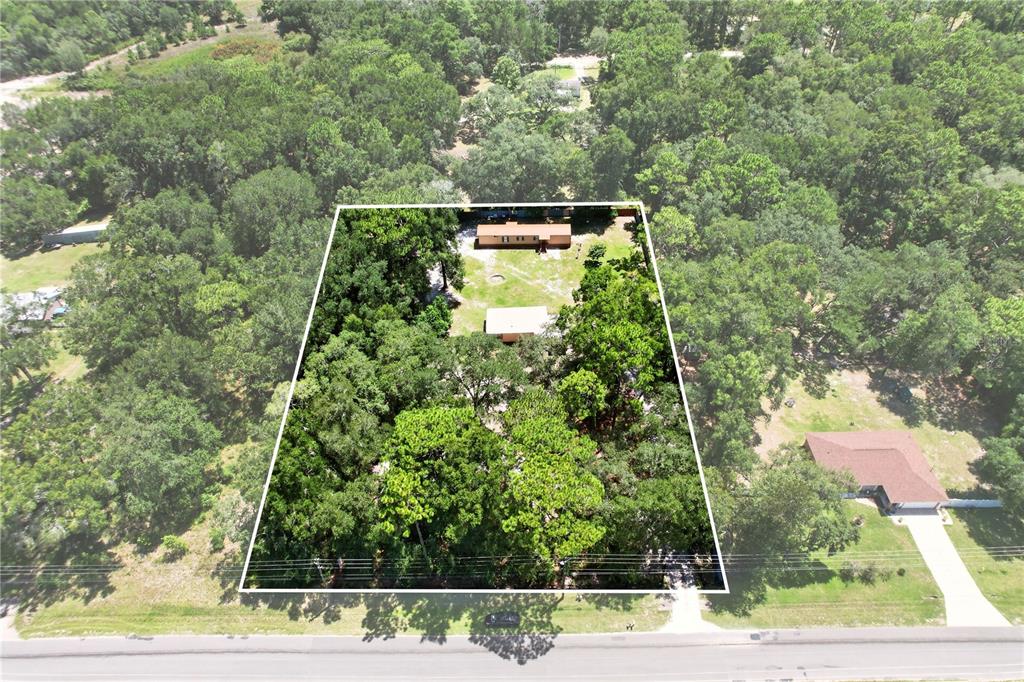 An aerial view shows a rectangular property lot containing a mobile home and outbuilding — 8200 SW 145 STREET, DUNNELLON, FL