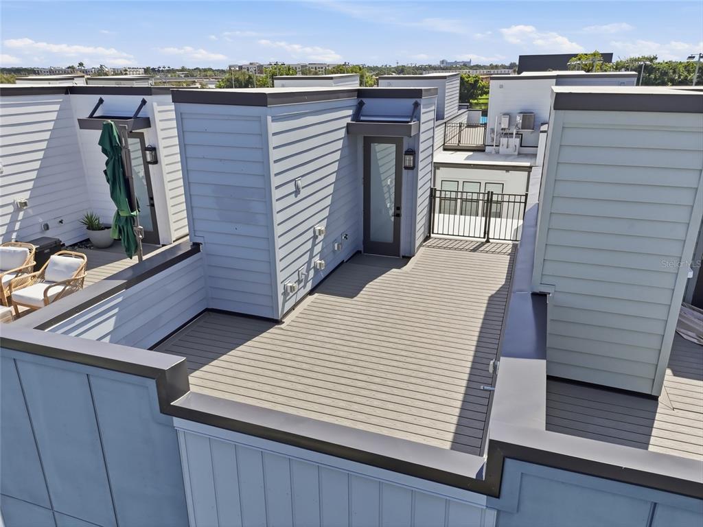 A rooftop deck with light-colored composite decking, a glass door, and a black metal railing — 2130 WHITNEY MARSH ALLEY, ORLANDO, FL