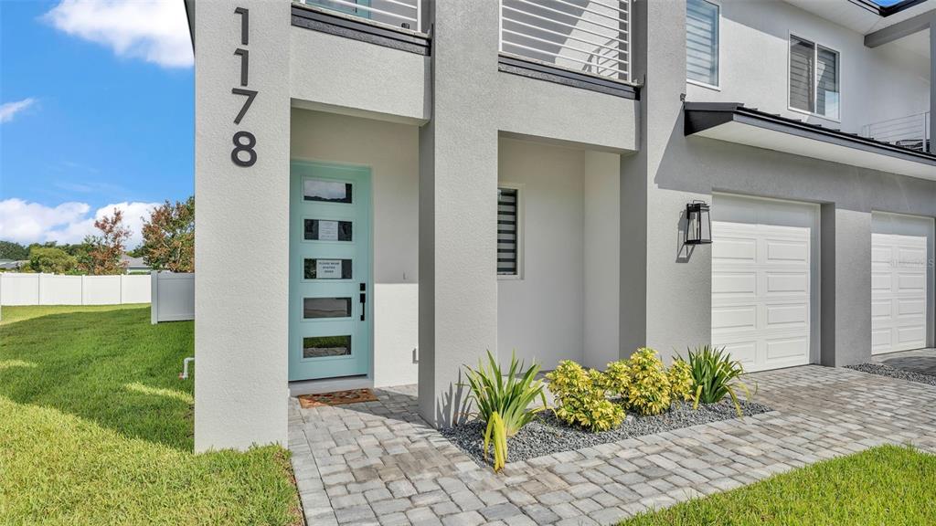 An aerial view of two modern, two-story duplex homes with white stucco and gray roofs — 1178 WINDJAMMER DRIVE, LAKELAND, FL