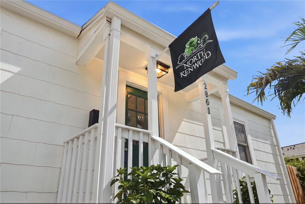 A white single-story house features a teal front door, a concrete driveway, and a palm tree — 2861 17TH AVENUE N, ST PETERSBURG, FL