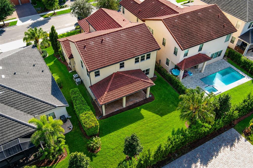 An exterior view of a two-story stucco house with a red tile roof and garage — 15149 CANOE PLACE, WINTER GARDEN, FL