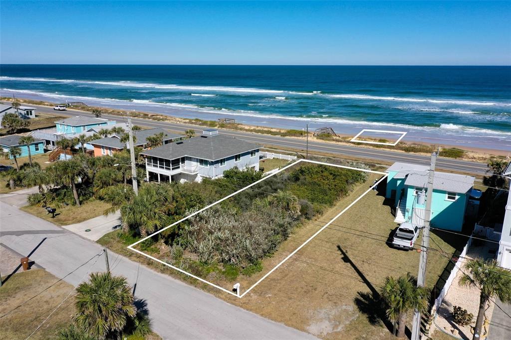 An aerial view shows a coastal neighborhood with houses, a road, and the ocean — 1922 N CENTRAL AVENUE, FLAGLER BEACH, FL