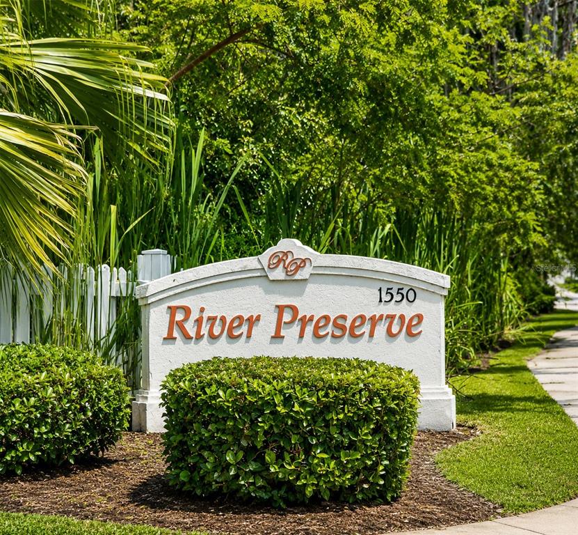 A white monument sign for River Preserve sits in front of lush green landscaping — 2607 RIVER PRESERVE COURT UNIT 2607, BRADENTON, FL
