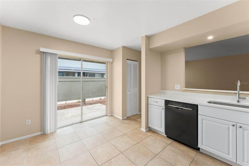 A concrete patio is enclosed by a privacy fence next to a house exterior — 4623 RING NECK ROAD UNIT B-1, ORLANDO, FL
