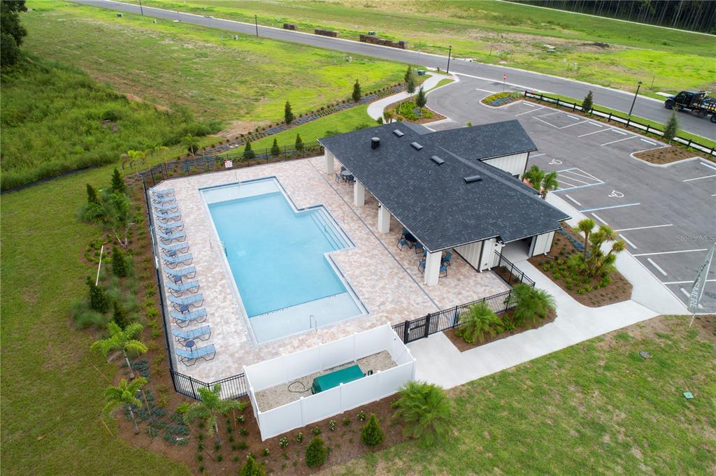 An aerial view of a community swimming pool and clubhouse with an adjacent parking lot — 2957 SWEETGRASS LANE, ZELLWOOD, FL