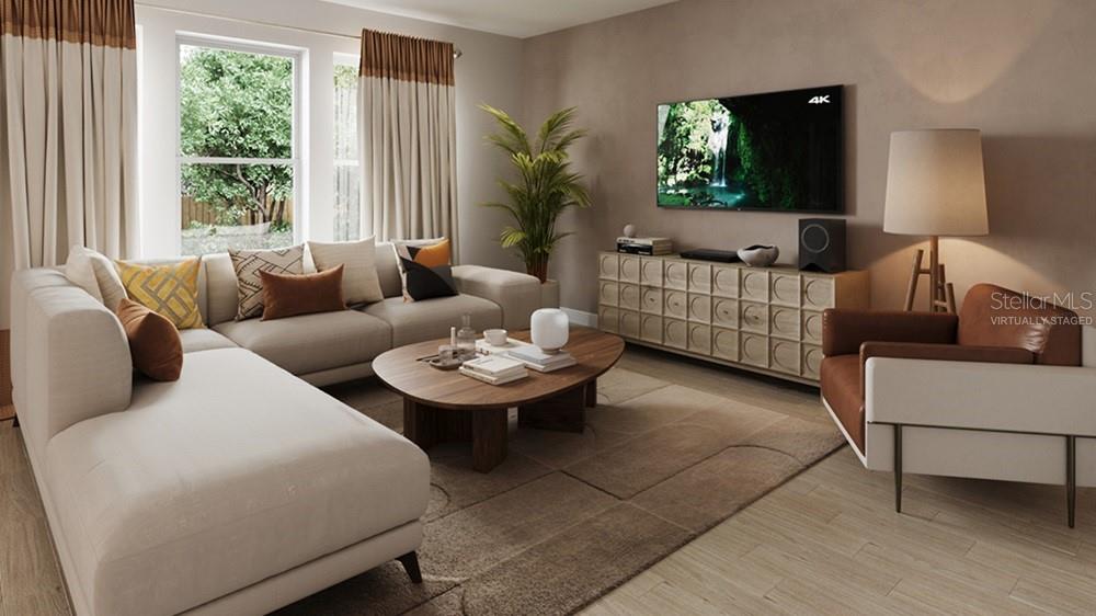 This virtually staged living room features a sectional sofa, coffee table, and media console — 7828 CENTAURUS WAY, SARASOTA, FL
