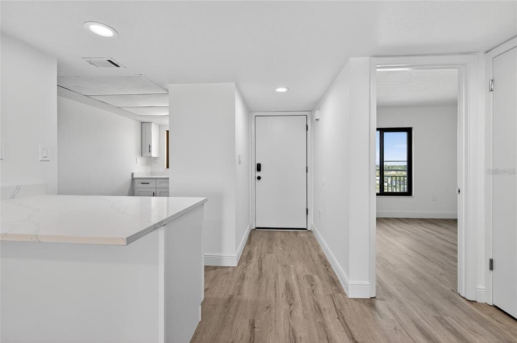 A view of a kitchen counter, an entryway door, and a doorway leading to a room — 1275 OCEAN SHORE BOULEVARD UNIT P3, ORMOND BEACH, FL