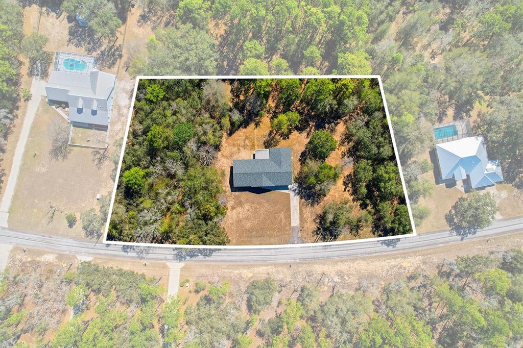 A light blue single-story house with a gray shingled roof and arched entryway — 700 E STRATFORD ROAD, LECANTO, FL